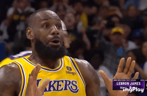 LeBron James raising both hands with a scared expression in a Lakers playoff game